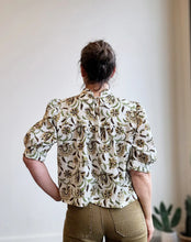 Load image into Gallery viewer, Person wearing a floral blouse with a plain background
