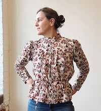 Load image into Gallery viewer, Woman wearing a floral blouse against a white wall