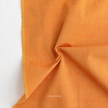 Load image into Gallery viewer, Close-up of orange fabric with 'PABLEISM' branding on a white background