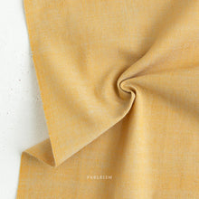 Load image into Gallery viewer, Close-up of yellow fabric with 'Fableism' branding on a light background