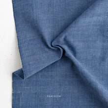 Load image into Gallery viewer, Close-up of blue fabric with 'Fableism' branding on a white background