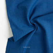 Load image into Gallery viewer, Close-up of blue fabric with 'Fableism' branding on a light background