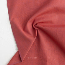 Load image into Gallery viewer, Close-up of red fabric with 'Fableism' branding on a white background