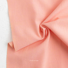 Load image into Gallery viewer, Close-up of pink fabric with 'Fableism' branding on a white background
